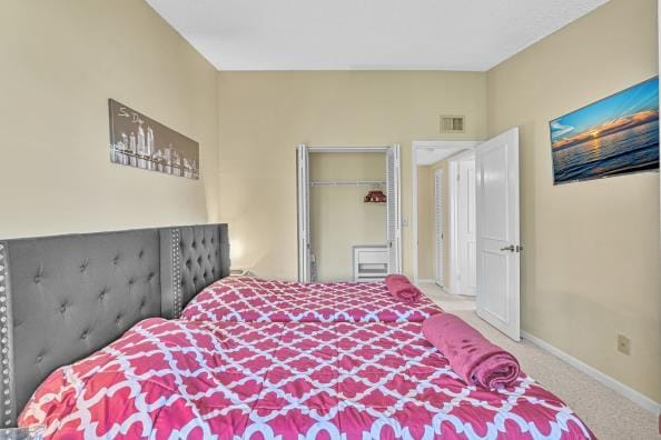 bedroom featuring carpet flooring and a closet