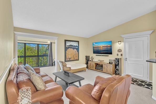 living room with light carpet and lofted ceiling