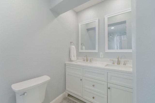 bathroom featuring vanity, a shower with shower curtain, and toilet