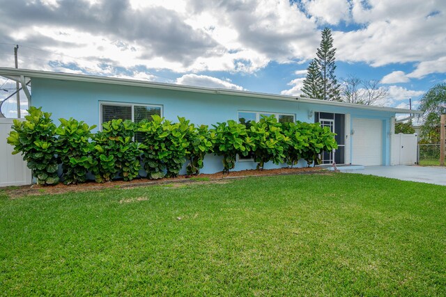 ranch-style home with a front yard and a garage