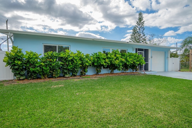 ranch-style home with a garage and a front yard