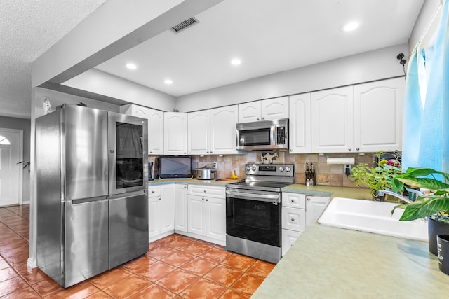 kitchen featuring white cabinets, stainless steel appliances, and sink