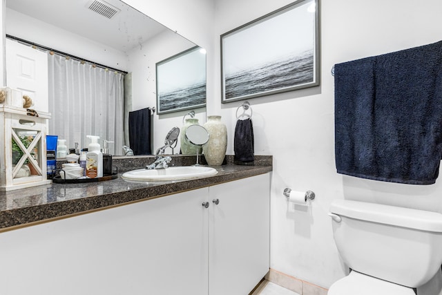 bathroom with tile patterned floors, vanity, and toilet