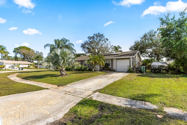 ranch-style house featuring a garage and a front yard