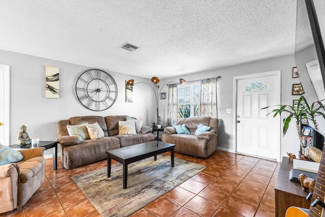 tiled living room with a textured ceiling