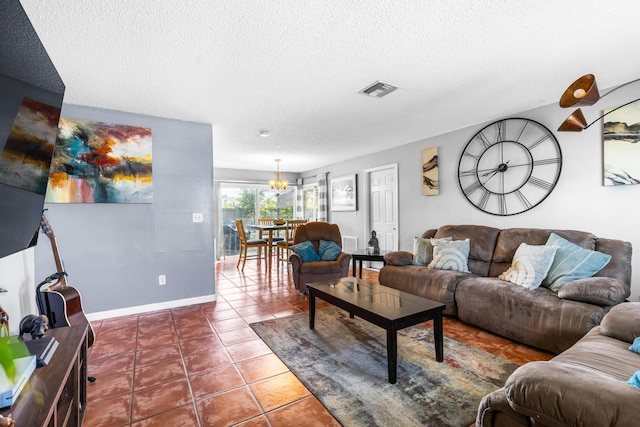 living room featuring tile patterned flooring, a textured ceiling, and an inviting chandelier