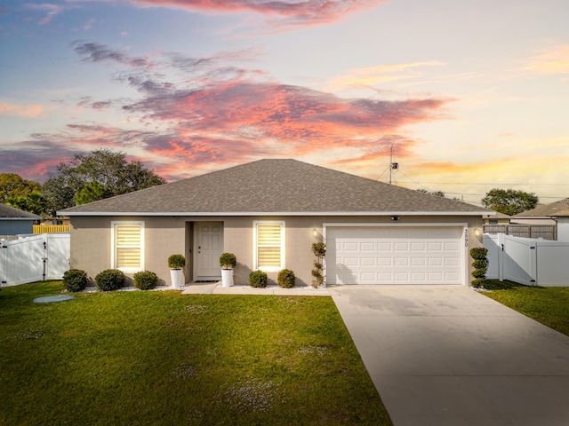 view of front of property featuring a yard and a garage