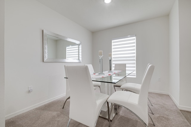 dining room featuring light colored carpet