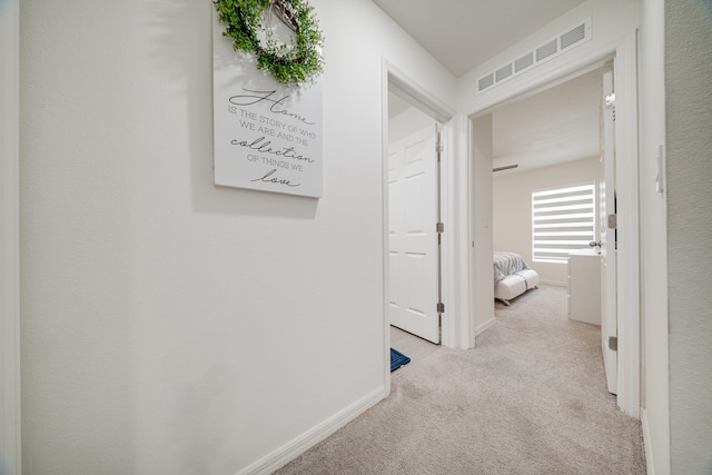 hallway with light carpet