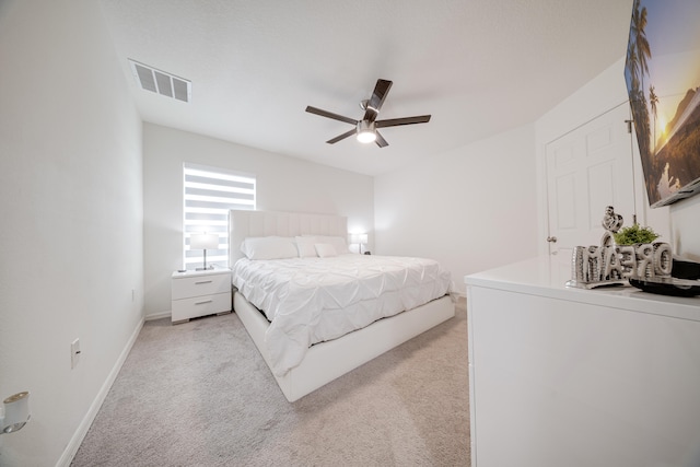 bedroom with ceiling fan and light carpet