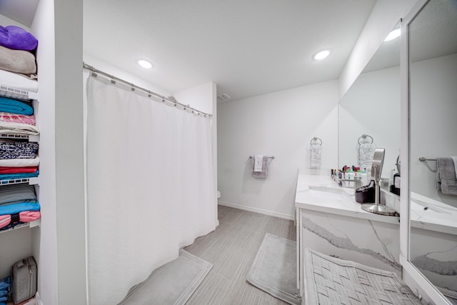 bathroom featuring vanity and curtained shower