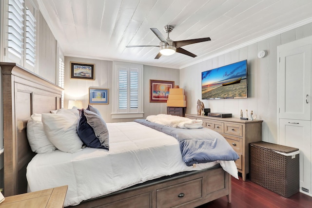 bedroom with dark hardwood / wood-style flooring, wood ceiling, ceiling fan, wooden walls, and crown molding