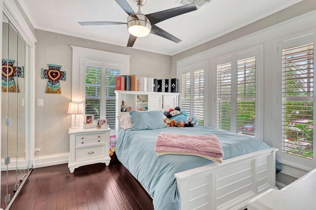 bedroom with ceiling fan, dark hardwood / wood-style flooring, and ornamental molding