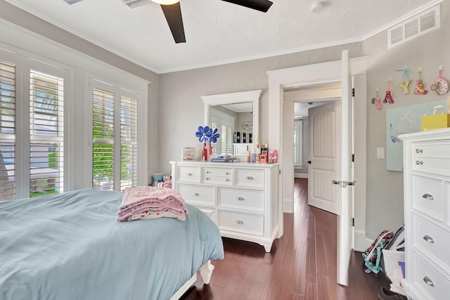 bedroom with dark hardwood / wood-style floors, ceiling fan, and ornamental molding