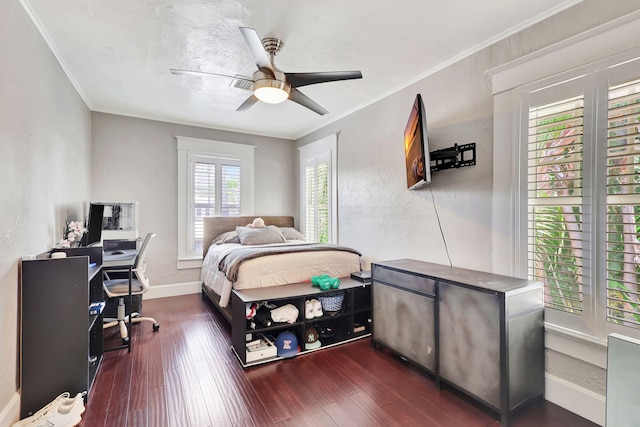 bedroom featuring crown molding, ceiling fan, and dark wood-type flooring