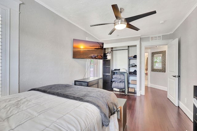 bedroom with dark hardwood / wood-style flooring, a closet, ceiling fan, and ornamental molding