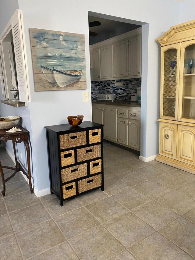 interior space featuring tile patterned flooring and decorative backsplash