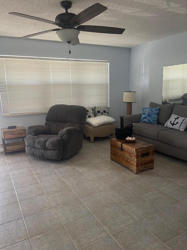 tiled living room with a textured ceiling and ceiling fan