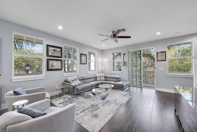 living room featuring ceiling fan and dark hardwood / wood-style flooring