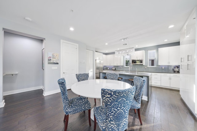 dining room featuring dark wood-type flooring and sink