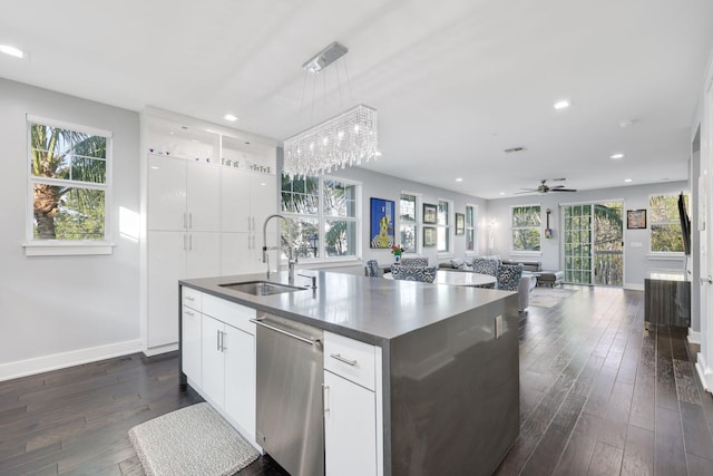 kitchen featuring dishwasher, decorative light fixtures, white cabinetry, and sink