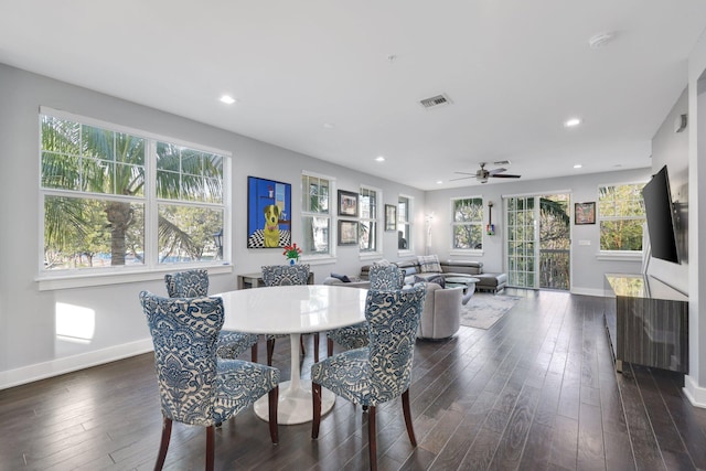 dining area featuring ceiling fan and dark wood-type flooring