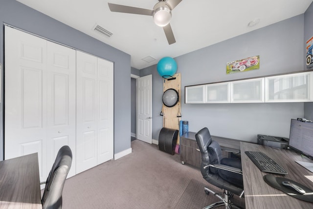 carpeted office space with ceiling fan