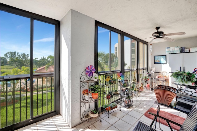 sunroom / solarium featuring ceiling fan