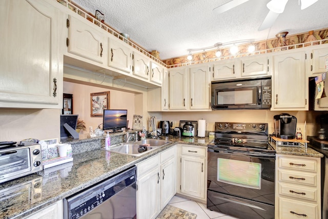 kitchen featuring sink, dark stone countertops, a textured ceiling, light tile patterned floors, and black appliances