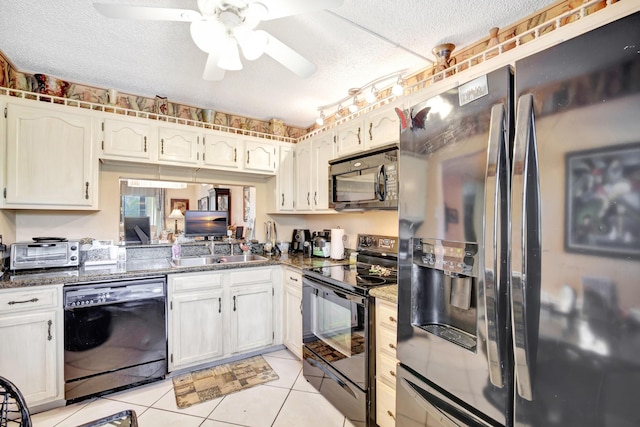 kitchen with black appliances, sink, ceiling fan, light tile patterned floors, and a textured ceiling