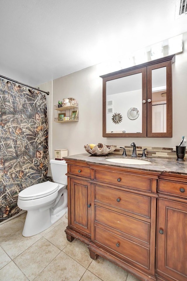 bathroom with tile patterned floors, vanity, curtained shower, and toilet