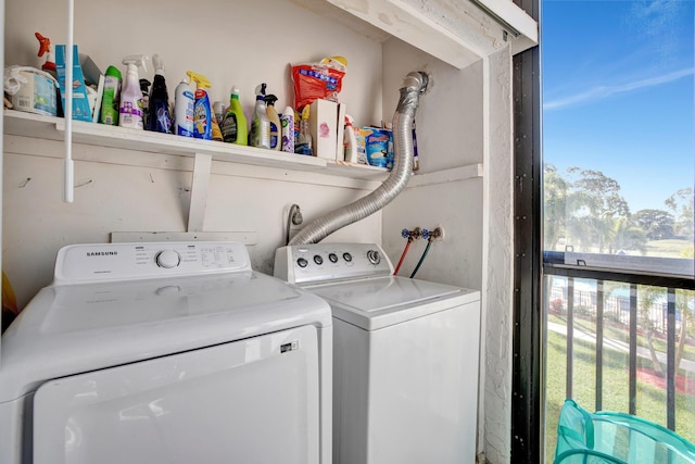 washroom featuring washing machine and clothes dryer and a healthy amount of sunlight