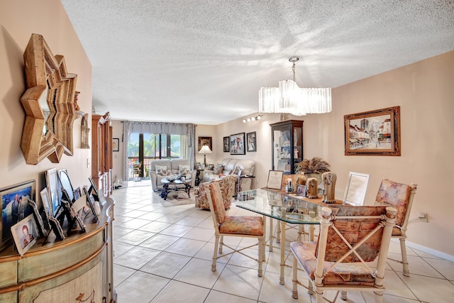 dining space with light tile patterned floors, a chandelier, and a textured ceiling