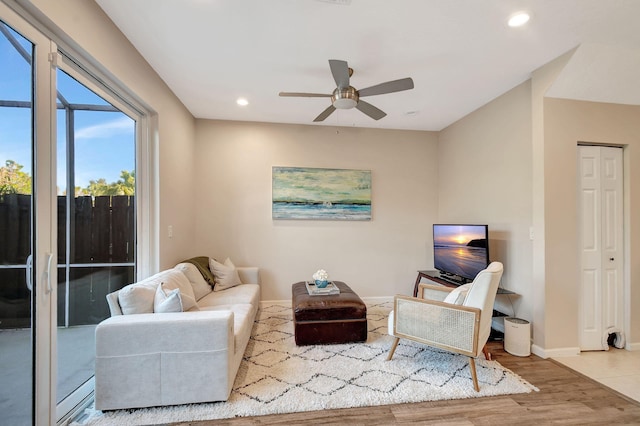 living room with hardwood / wood-style flooring and ceiling fan