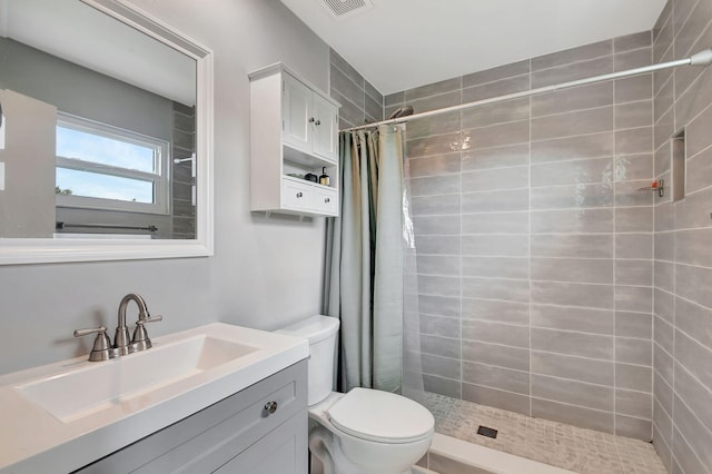 bathroom featuring vanity, toilet, and walk in shower