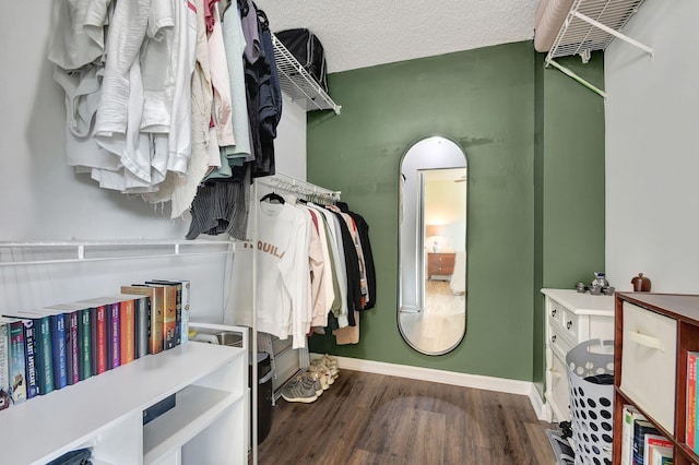 walk in closet featuring dark hardwood / wood-style flooring