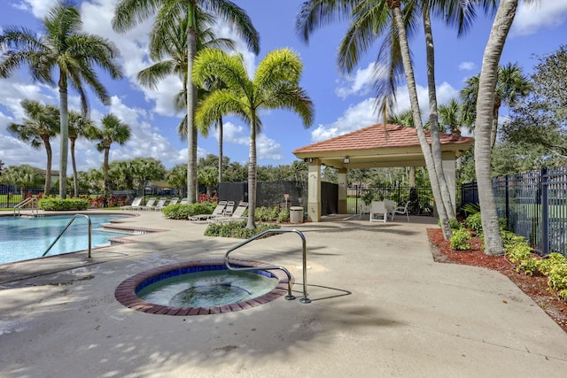 view of pool featuring a patio area and a hot tub