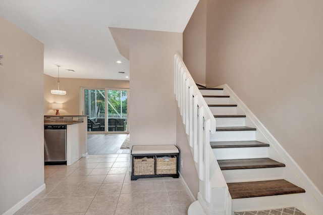 stairs featuring tile patterned flooring