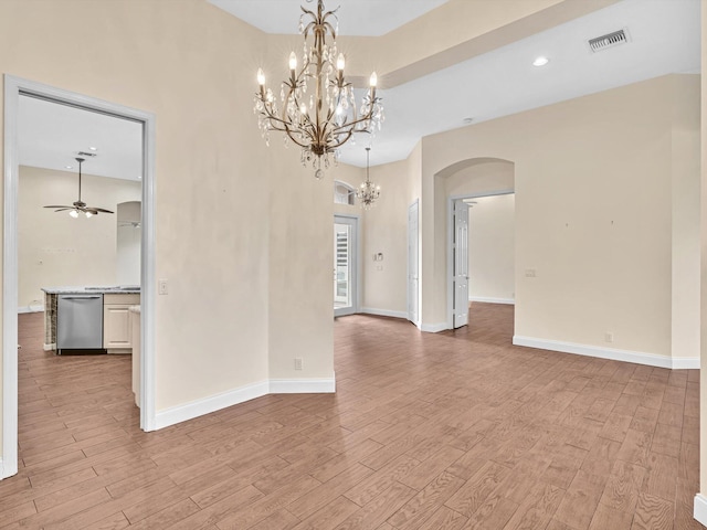 unfurnished room featuring light hardwood / wood-style floors and ceiling fan with notable chandelier