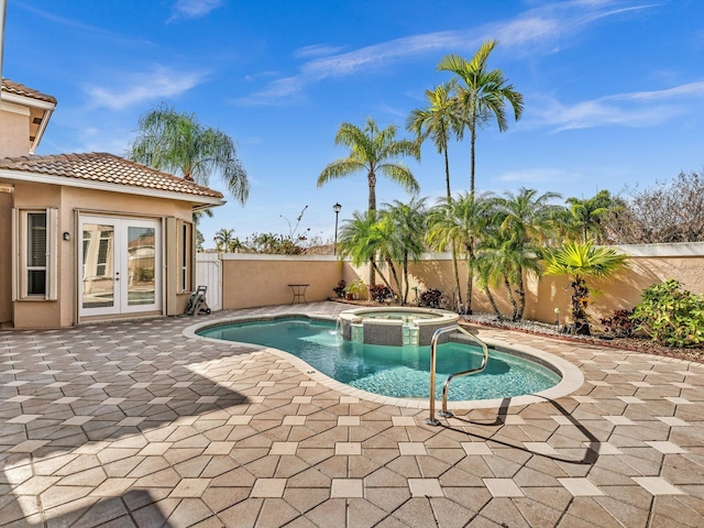 view of pool with an in ground hot tub, a patio, and french doors