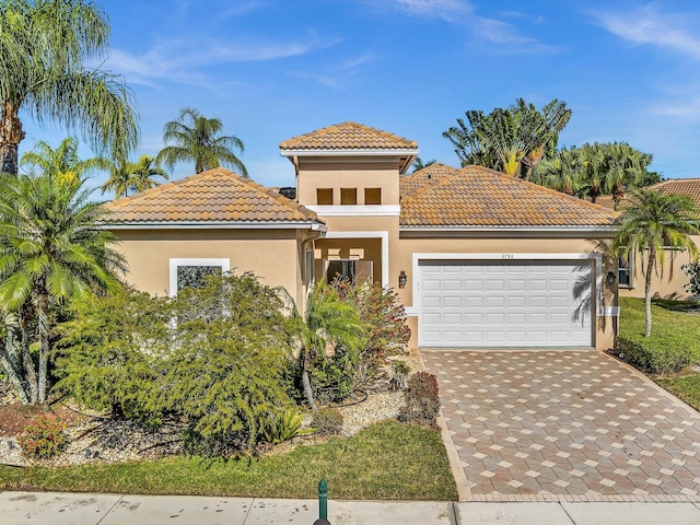 mediterranean / spanish home featuring a garage