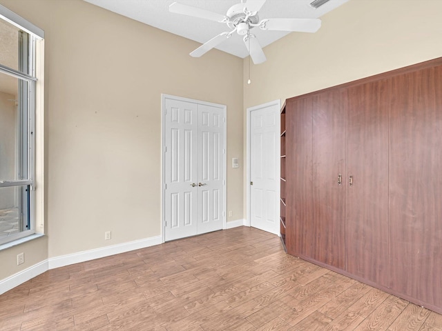 unfurnished bedroom with ceiling fan and light wood-type flooring