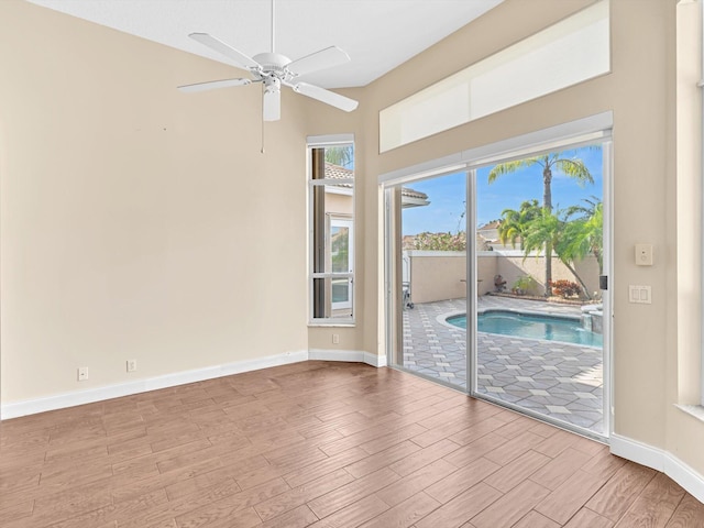 unfurnished room featuring light hardwood / wood-style floors and ceiling fan