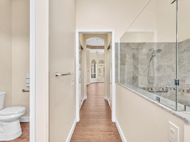 corridor with hardwood / wood-style flooring