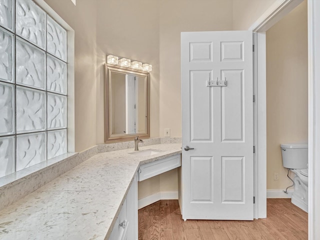 bathroom featuring hardwood / wood-style floors, vanity, and toilet