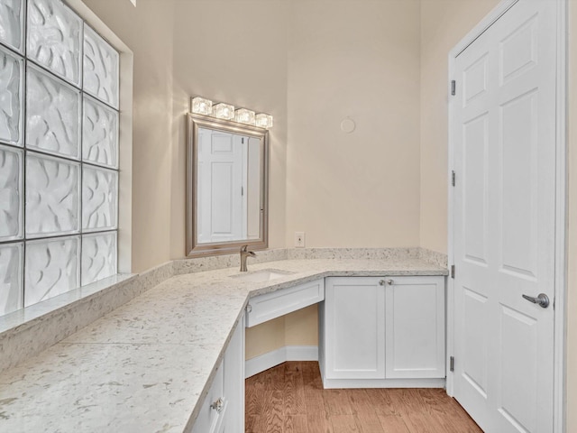 bathroom featuring hardwood / wood-style flooring and vanity