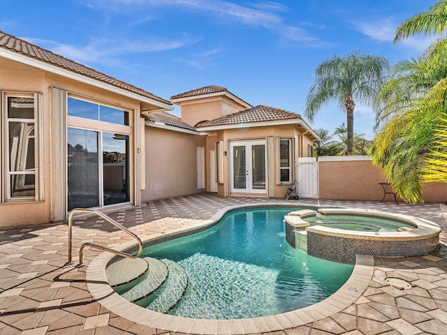 view of pool featuring an in ground hot tub, a patio area, and french doors