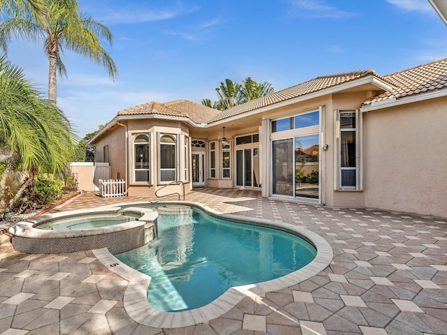 view of pool with an in ground hot tub and a patio