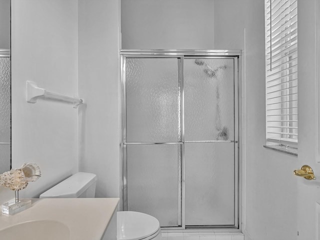 bathroom featuring toilet, an enclosed shower, and vanity