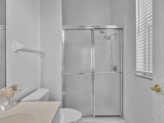 bathroom featuring walk in shower, vanity, and toilet